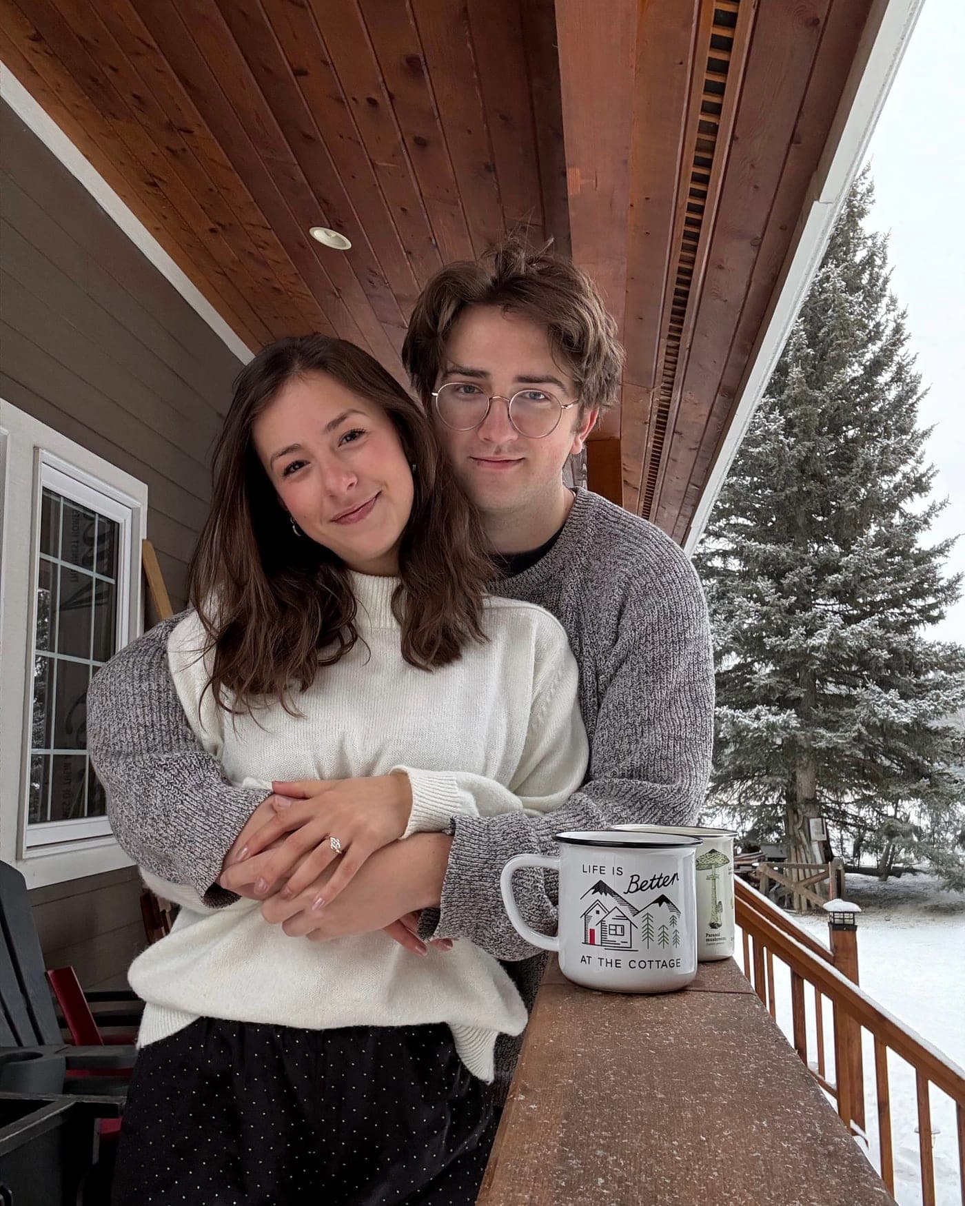 Avrille and Maxwell on a snowy cottage porch.